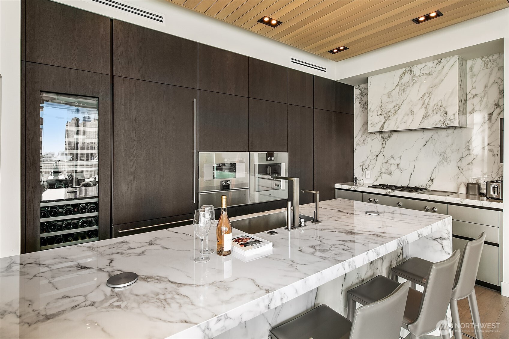 peninsula slab marble hand selected with matching back splash along wall of cook top