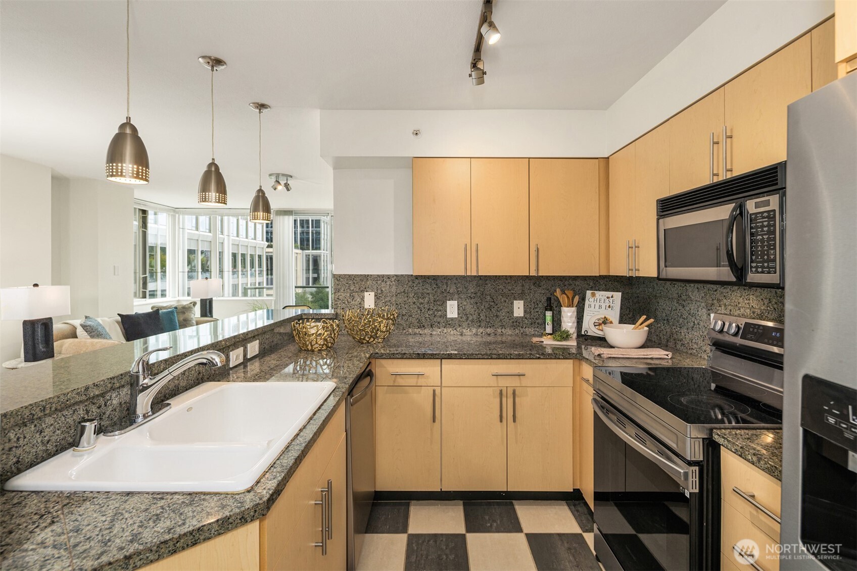 The kitchen features granite counters, tons of cabinet storage, and a deep pantry.