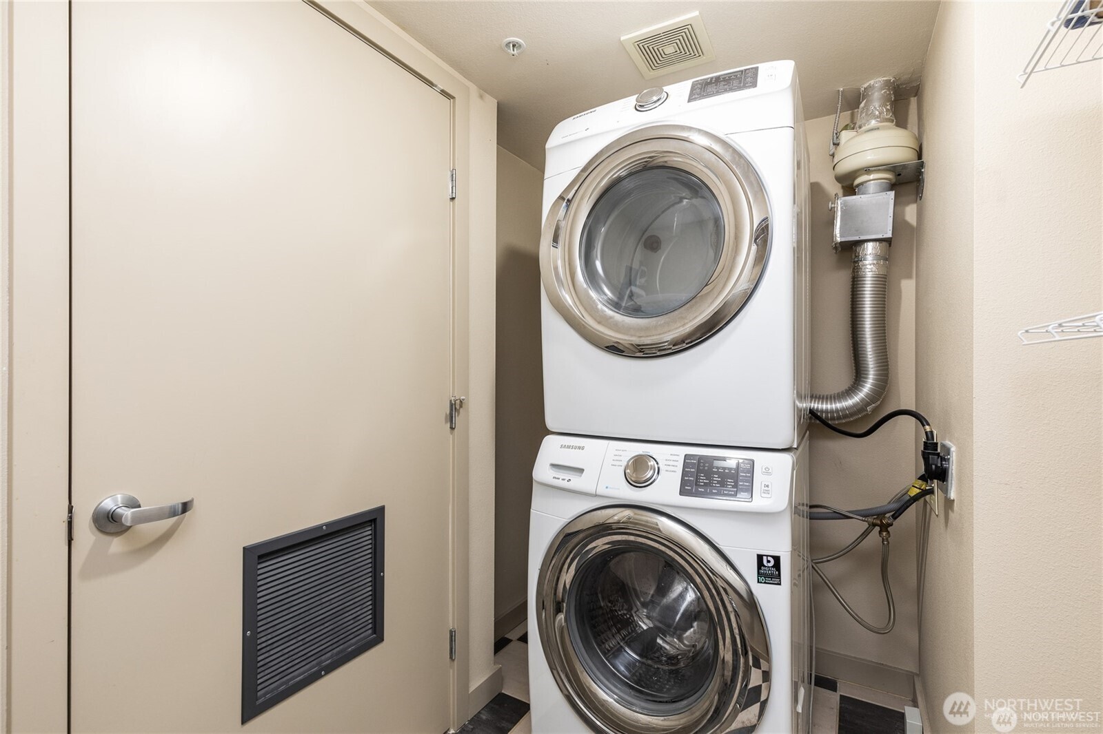 A stacked washer and dryer maximizes the utility closet's space.