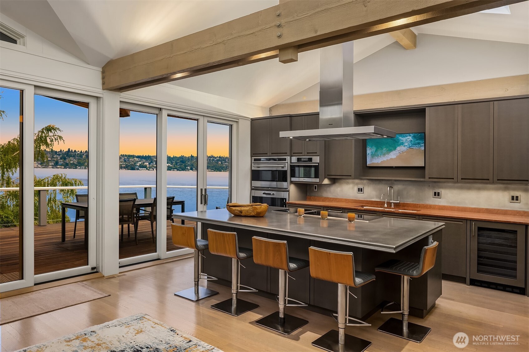 Modern, chef's kitchen with large pewter island, vaulted ceilings, Wolf & Miele appliances.