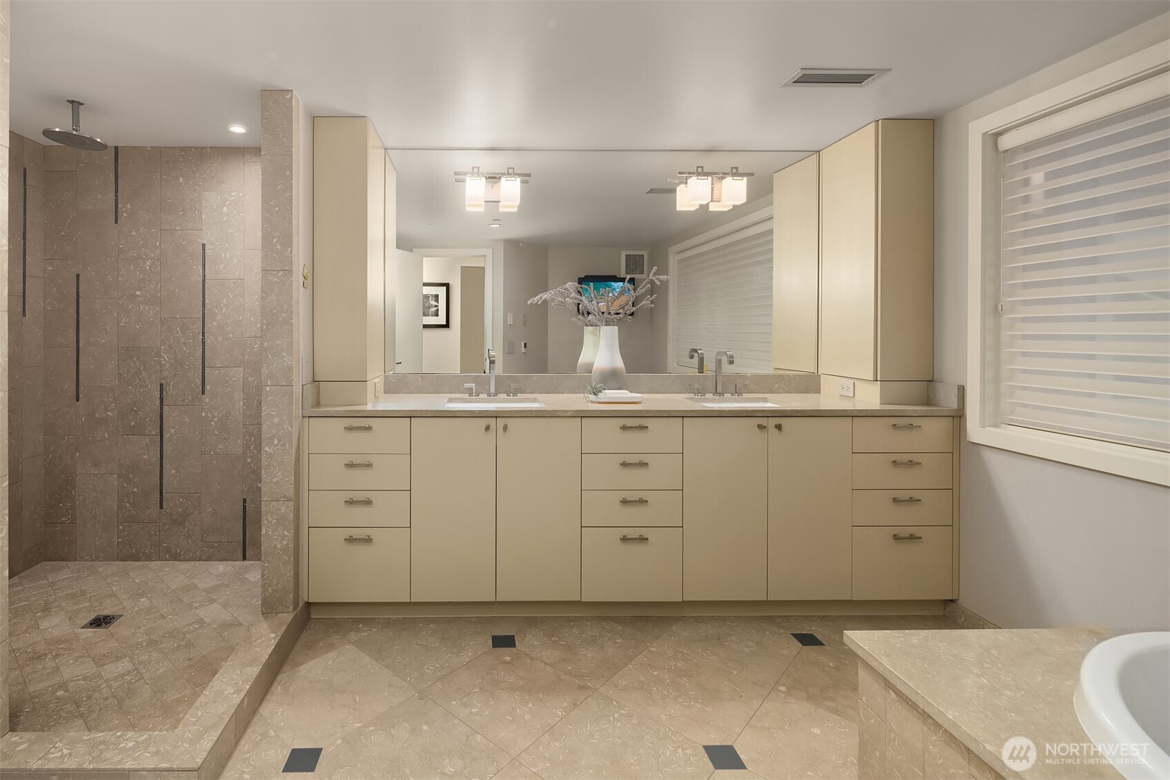 The primary's en suite 5-piece bathroom complete with walk-in shower and jetted, soaking tub.