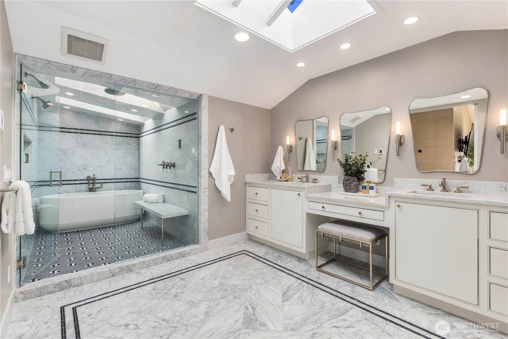 Newly reimagined Carrara marble bath, steam shower, Kallista fixtures, and laundry.