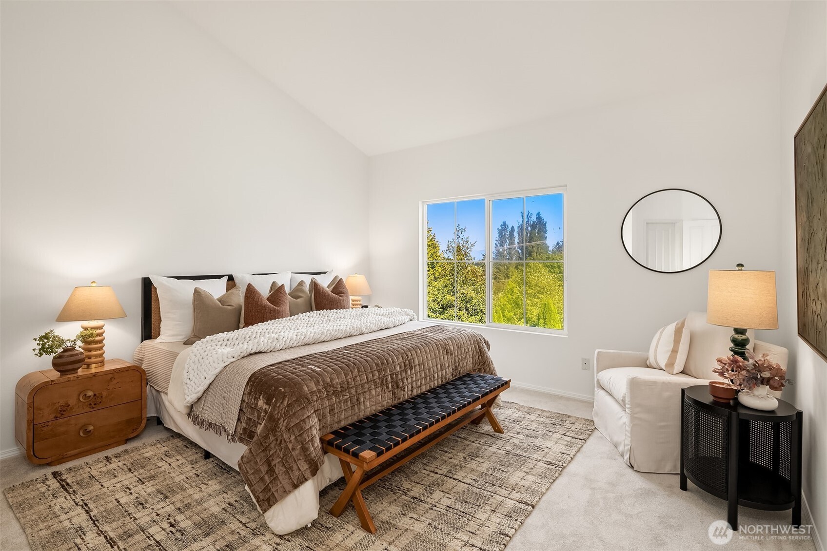 Also on the main, your vaulted primary suite offers more lovely views.