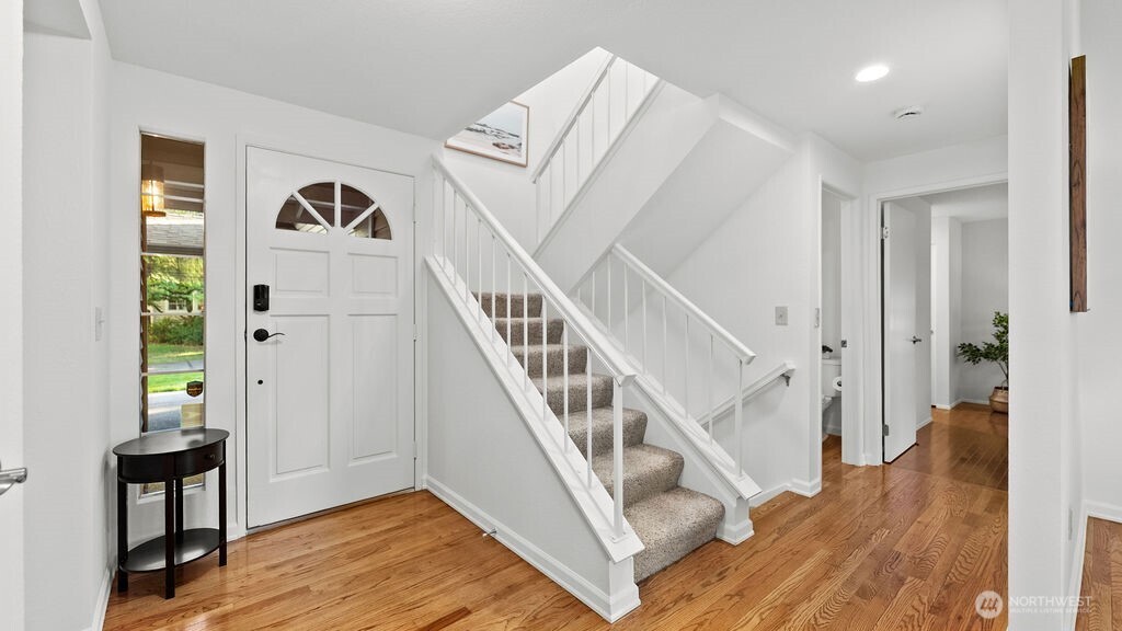 Inviting hardwood entry with access to main floor living room, dining room and primarty bedroom on the mainfloor plus a convenient extra 1/2 bath.