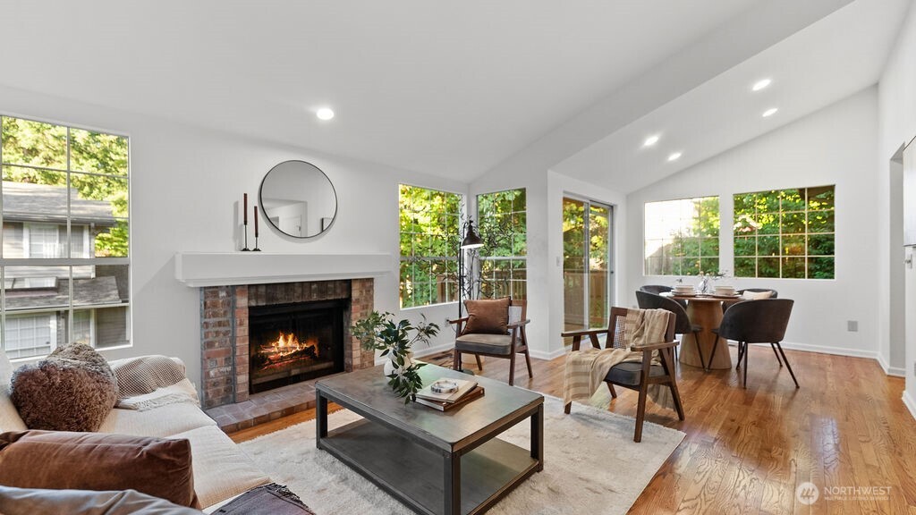 Vaulted ceilings and a cozy fireplace welcome you into the elegant living room.
