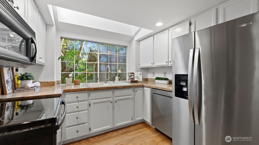 A skylight brights fill the convenient kitchen with sunlight.